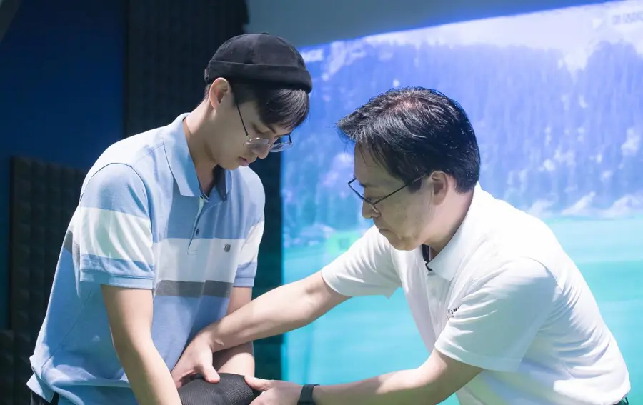 Coach working with a student in a bay